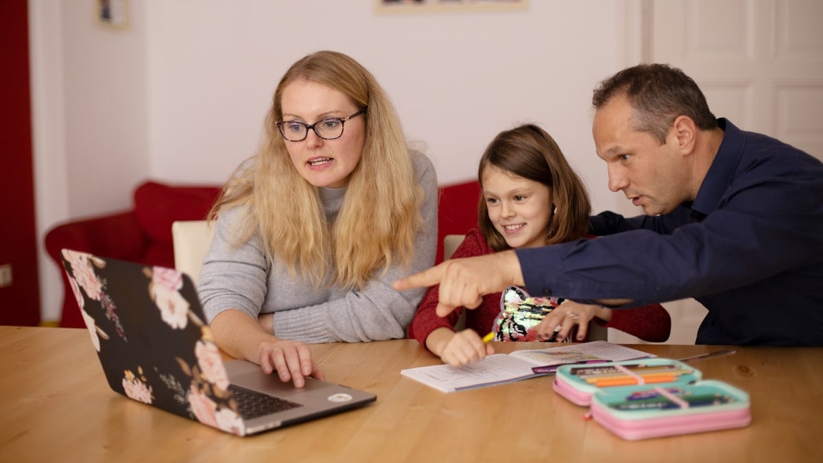 Parents learning teaching their child during homeschooling.